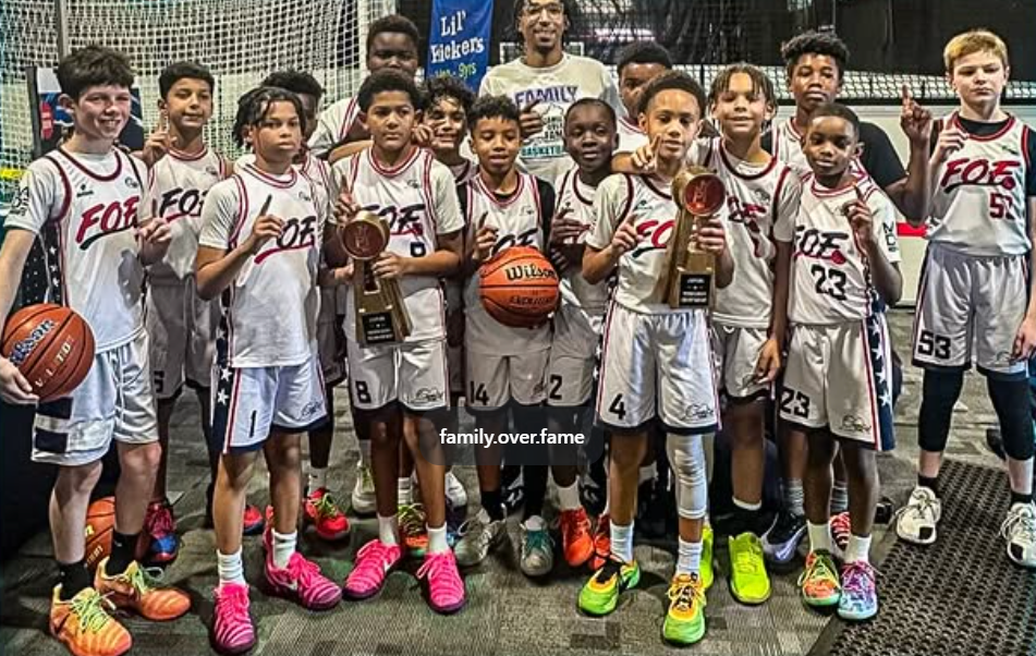 Family Over Fame youth basketball team with championship trophies